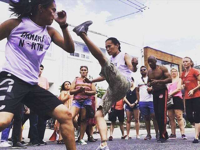Monitora Calada and Monitora Sorriso playing in a street roda at a Kensington Park Car Free Sunday event